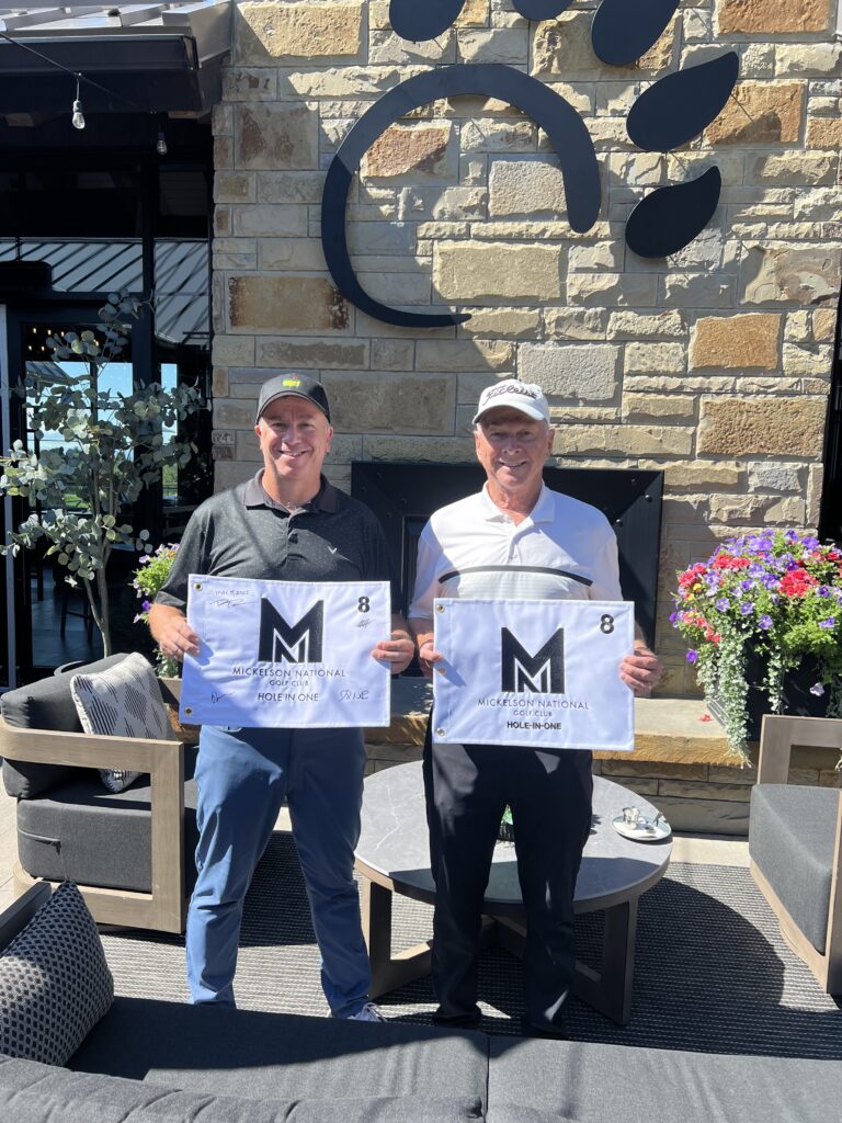 Brian and Jim holding their Hole in One flags from Mickelson National Golf Club, which they got on the same hole.